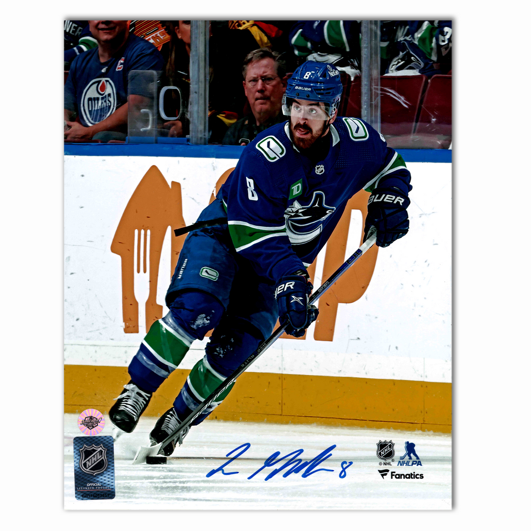 Conor Garland Autographed Vancouver Canucks Home 8x10 Photo (With Puck)